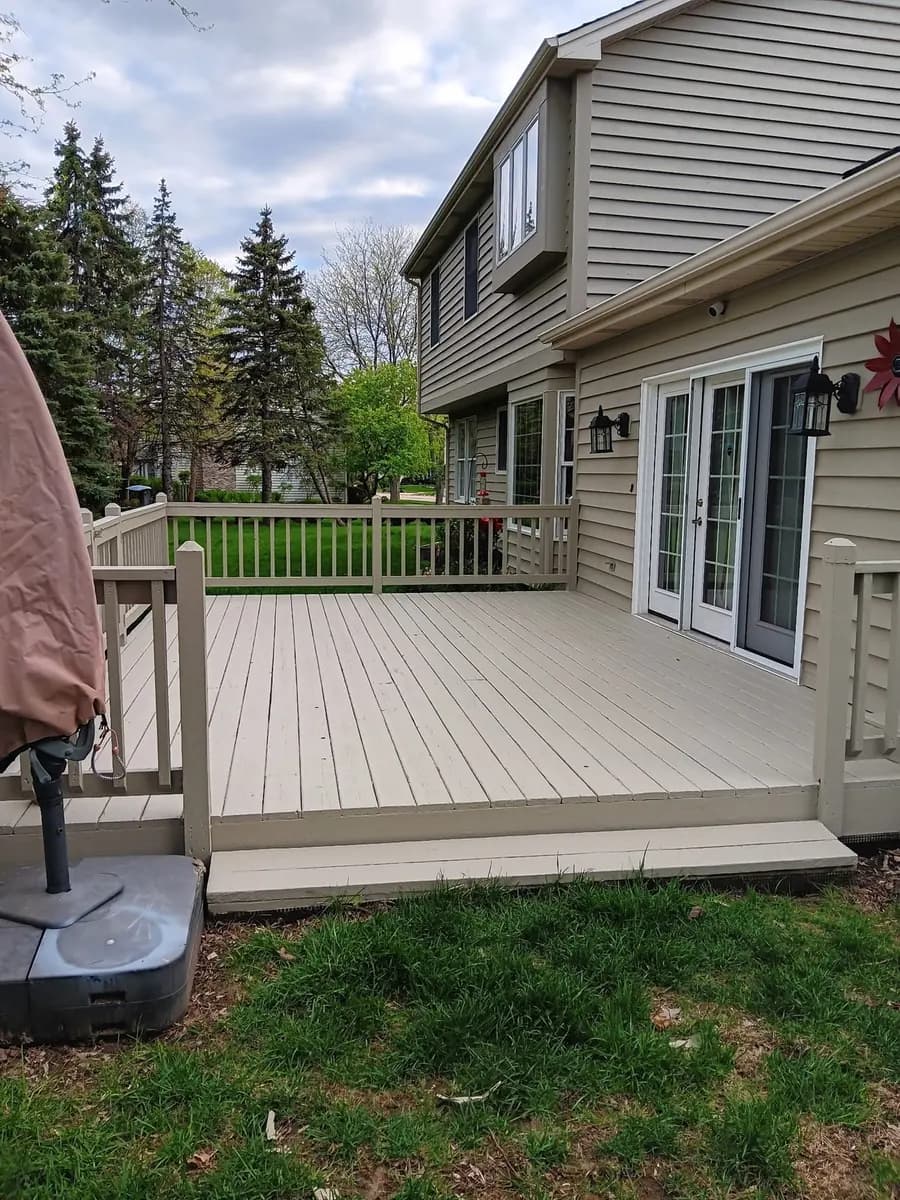 Completed deck refinishing viewed from the yard.