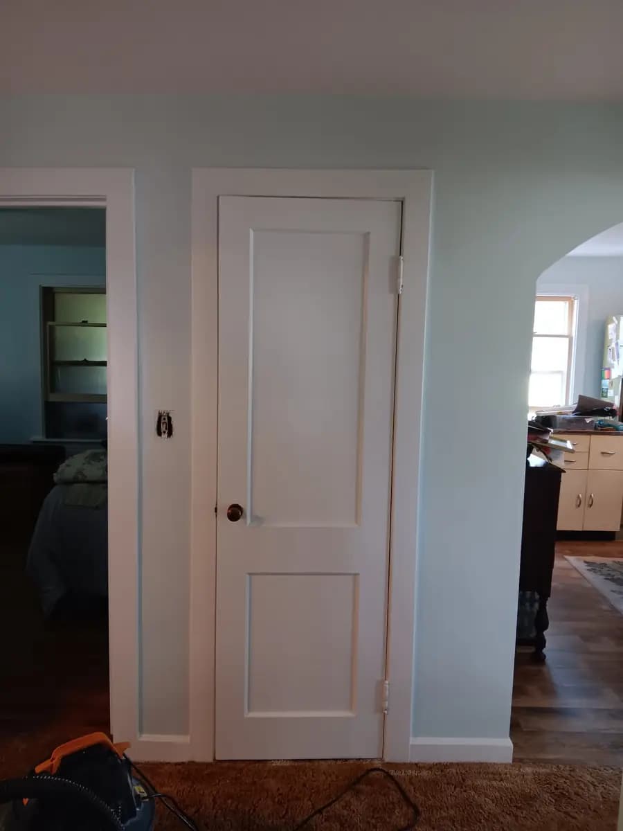 Repainted white door and trim against the new wall color.